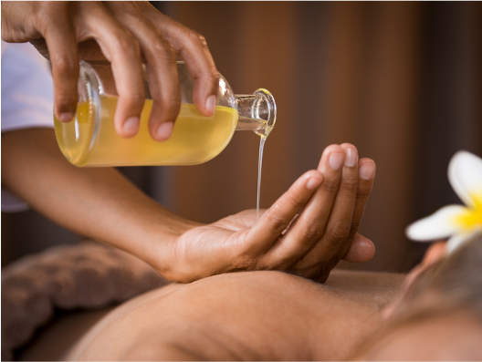 Warm oil being poured for an aromatherapy massage